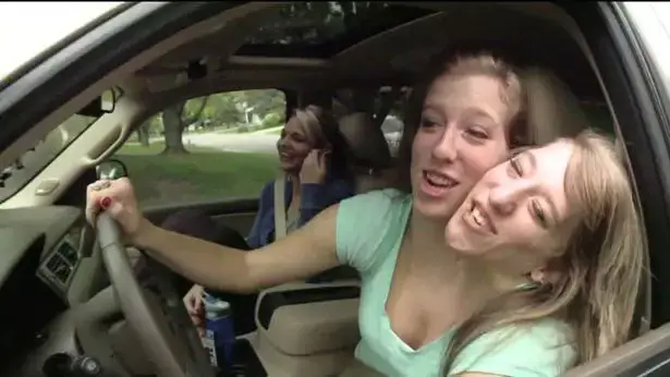 Abby and Brittany Hensel driving a car